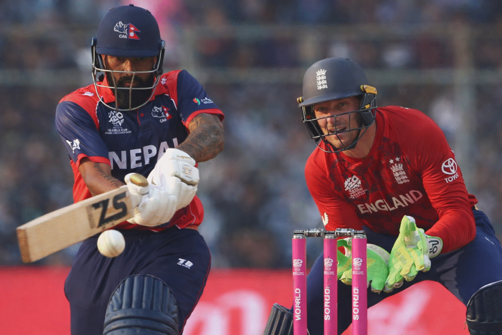 Nepal vs England T20 World Cup 2026 मैच में नेपाल का बल्लेबाज़ शॉट खेलते हुए और इंग्लैंड का विकेटकीपर गेंद पर नज़र बनाए हुए।