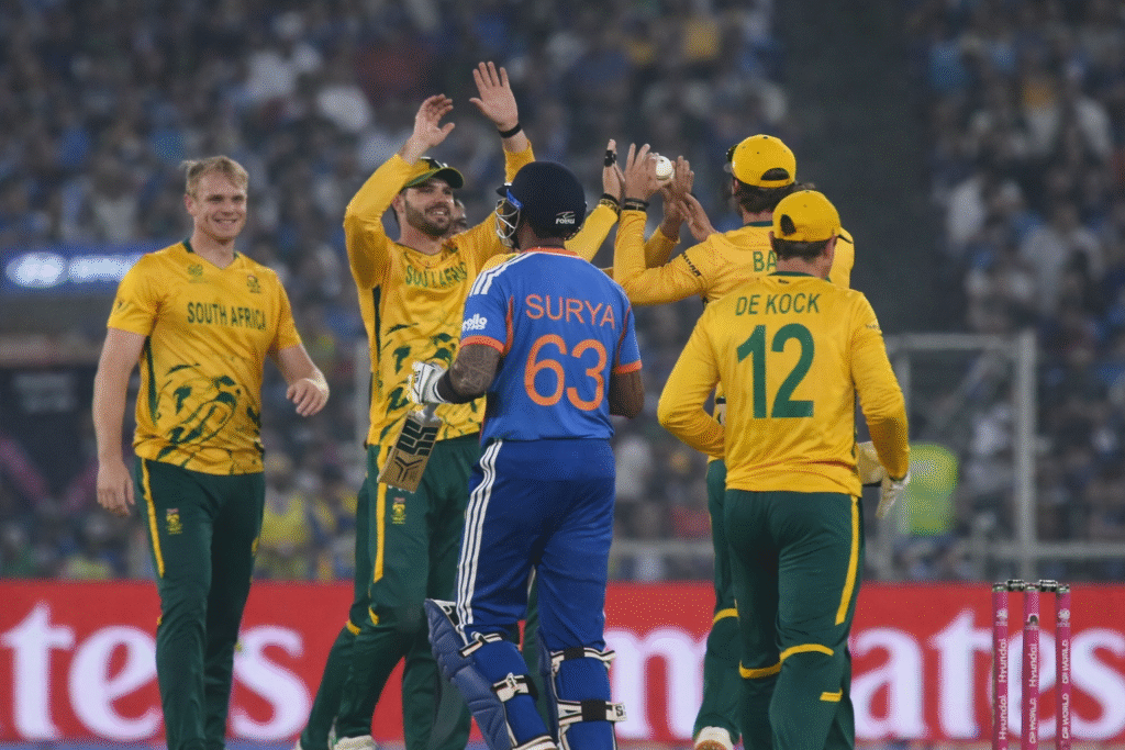 India cricket team batsman walking back after dismissal while South Africa cricket team players celebrate a wicket during an international cricket match in a stadium