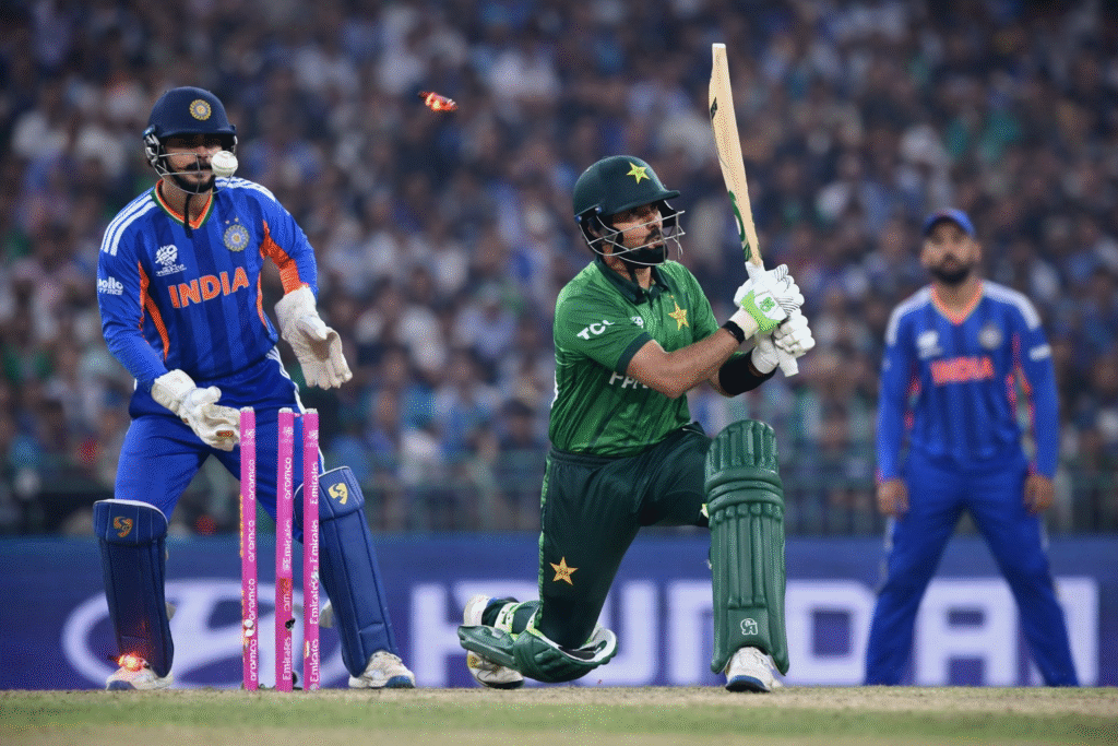 India vs Pakistan T20 World Cup match moment showing Pakistani batsman playing a shot while Indian wicketkeeper stands behind the stumps with bails dislodged in a packed stadium.