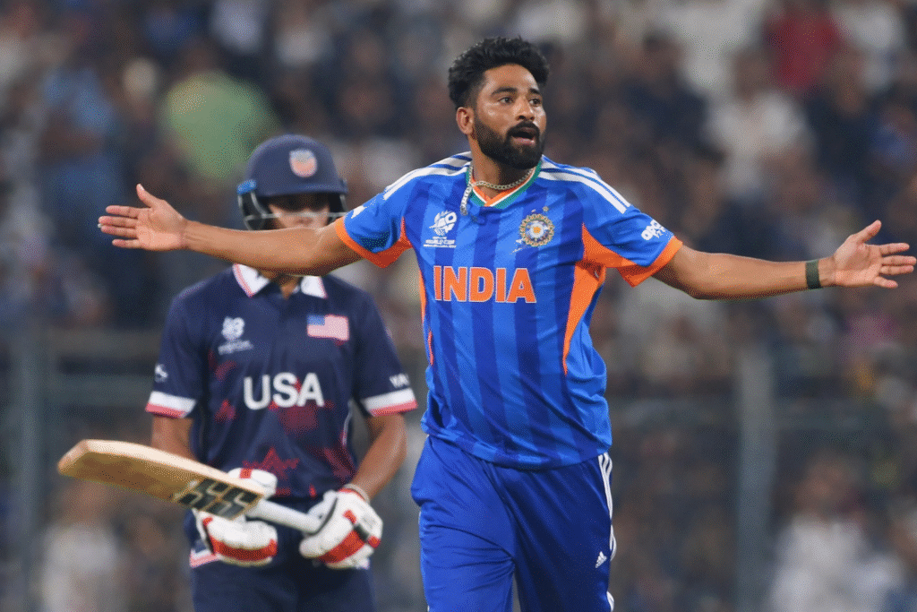 Indian cricketer celebrating a wicket with arms outstretched during India vs USA ICC Men’s T20 World Cup 2026 match, stadium crowd in background